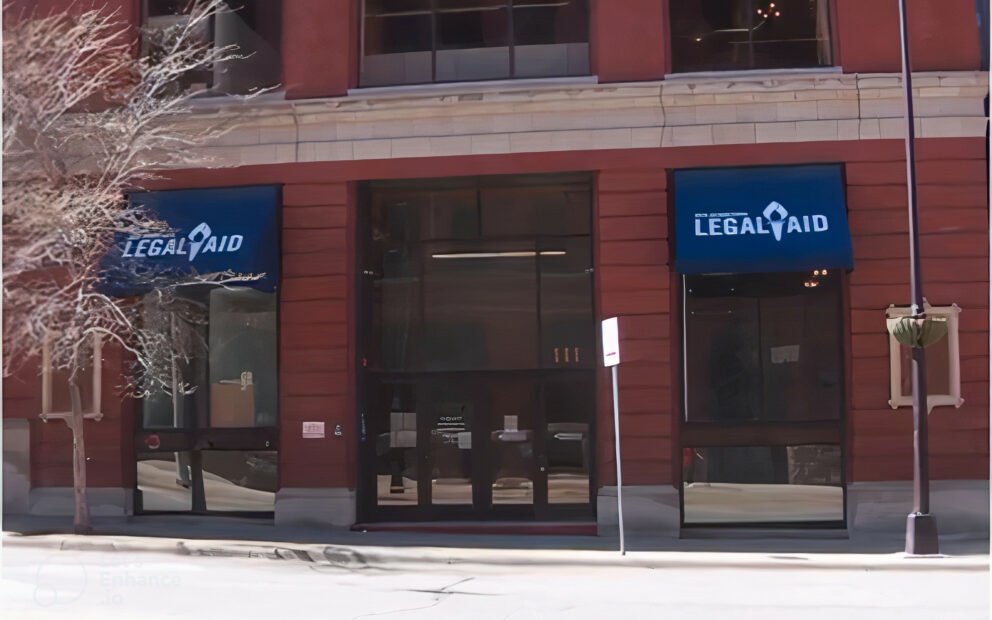 Brick building, dark blue exterior awnings with Legal Aid in white lettering