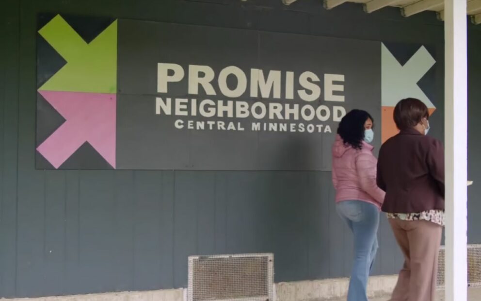 Building signage, white letters on gray background, reads: Promise Neighborhood Central Minnesota.
