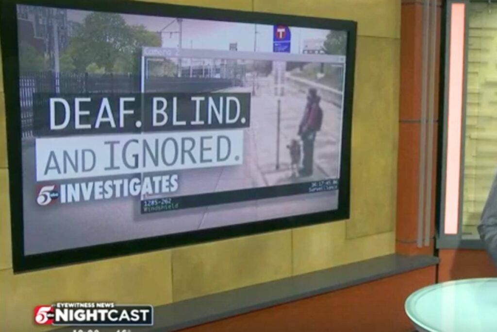 TV news set background screen displays words: Deaf. Blind. And Ignored. 5 investigates over image of Barry Segal waiting at bus stop.
