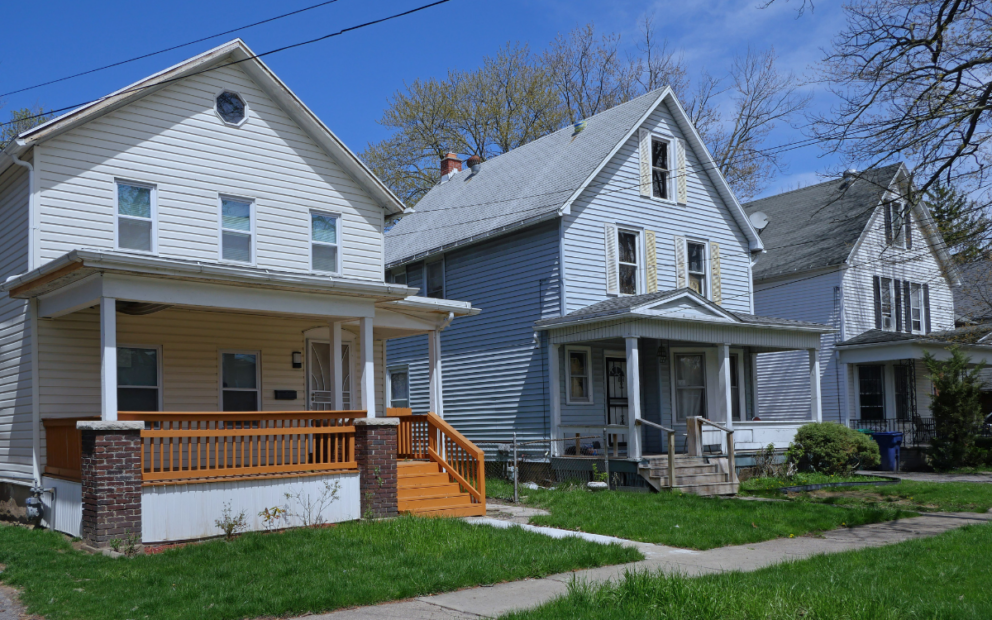 Three older two-story homes with porches.