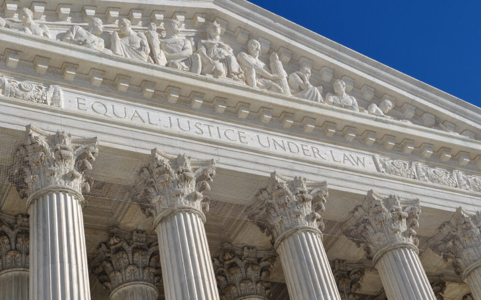 Portico of the U.S. Supreme Court building with focus on the etching above that reads Equal Justice Under Law