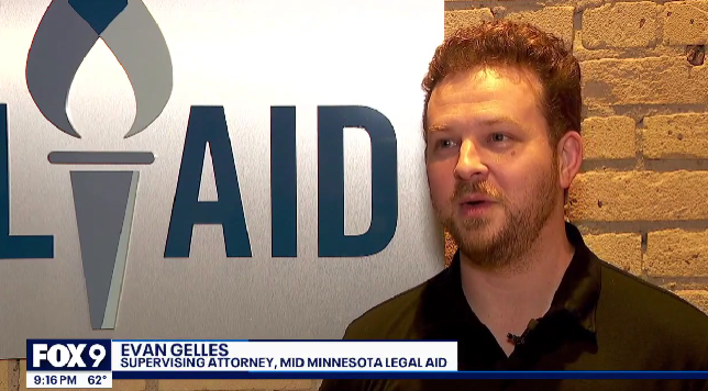 Man with short hair, dark polo shirt against backdrop of brick wall and sign that says Legal Aid with Fox9 news banner identifying him as Evan Gelles, Supervising Attorney