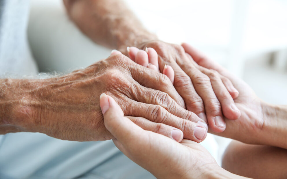 Hands of two people intertwined