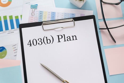 Background of colorful graphs with a clipboard and pen in foreground with words 403(b) plan