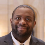 man smiling in a capitol building