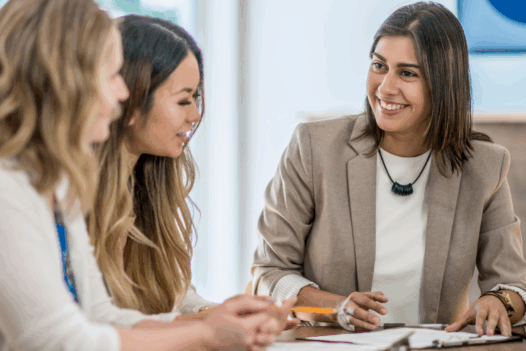 group of three women talking and smiling