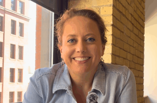 woman in blue shirt smiling