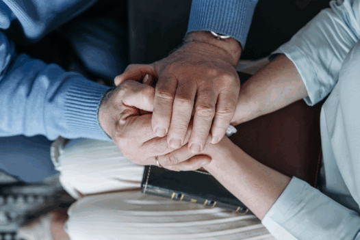 hands clasped together