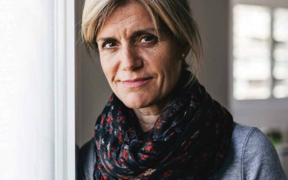 woman standing wearing an infinity scarf