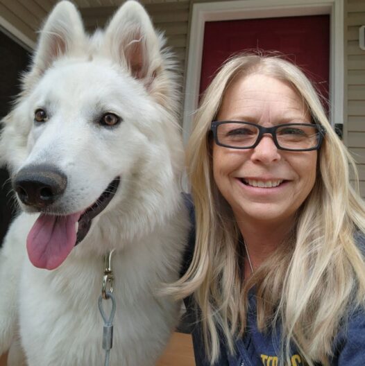 woman sitting next to dog