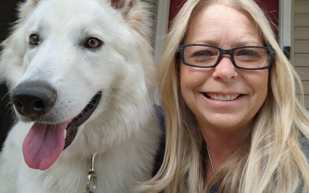 woman sitting next to dog