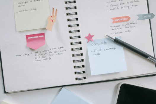 a notebook with sticky notes