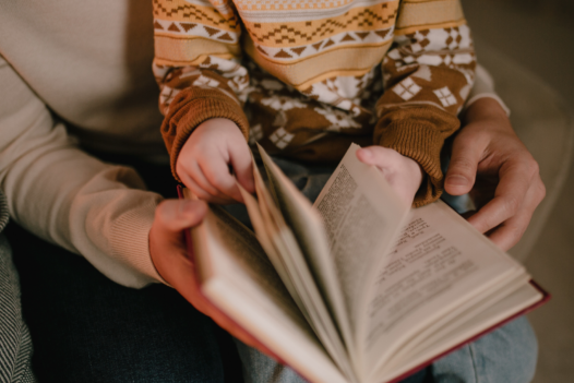 mother and child holding a book