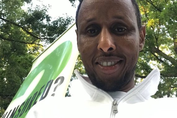 man with trees behind him