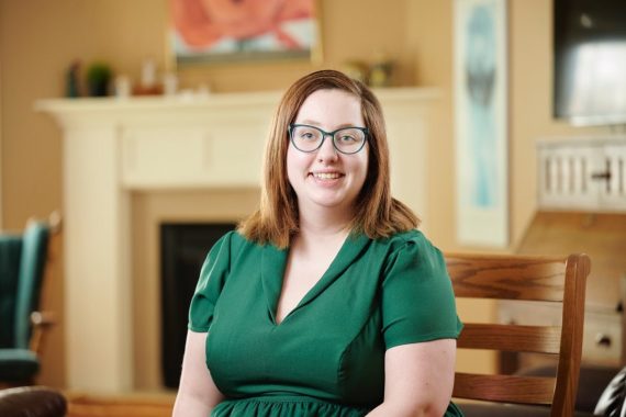 woman sitting wearing a green blouse