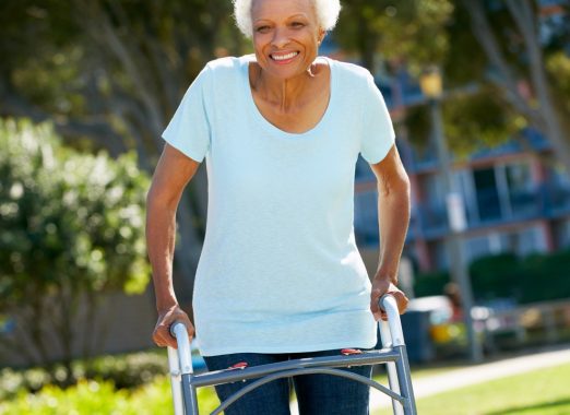 elderly woman using walker outdoors