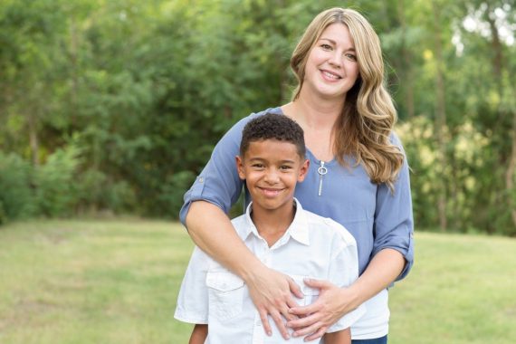 mother and son standing in a field