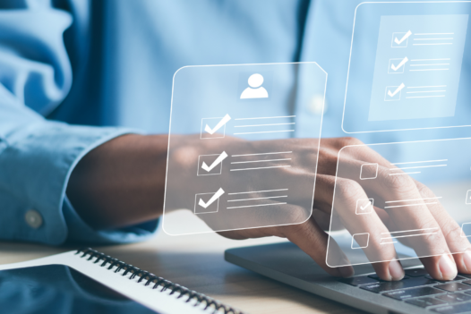 person typing on computer with checklist graphic in front
