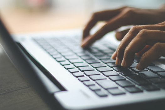 person typing on a laptop