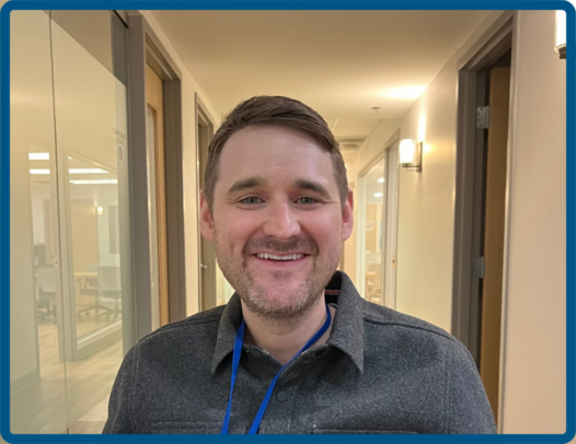 person smiling in a hallway