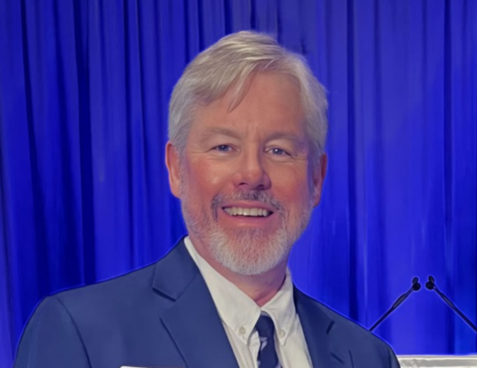 Man wearing a suit, smiling