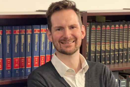 person standing in front of a bookshelf
